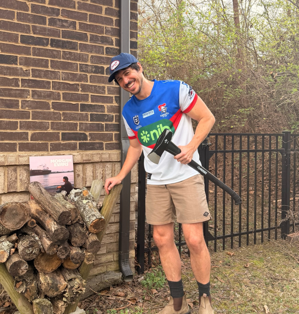 Evans pose for photos chopping wood, captioning the post, 